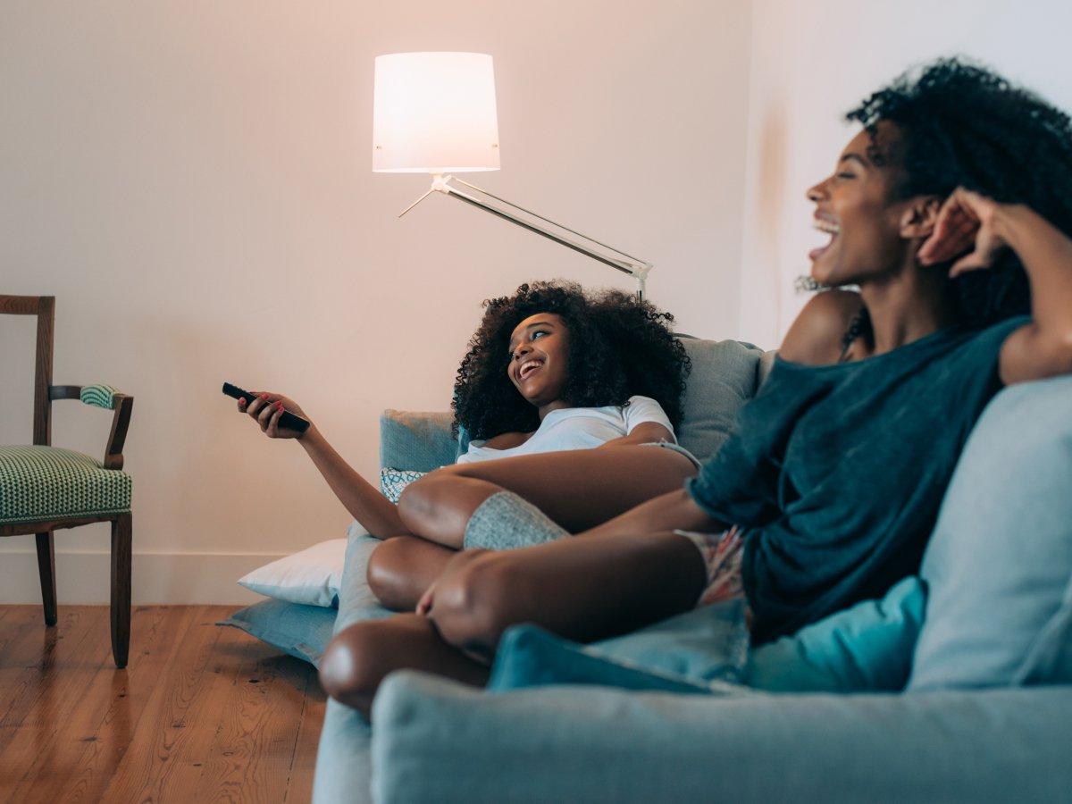 AHS Customers smiling watching TV on a couch